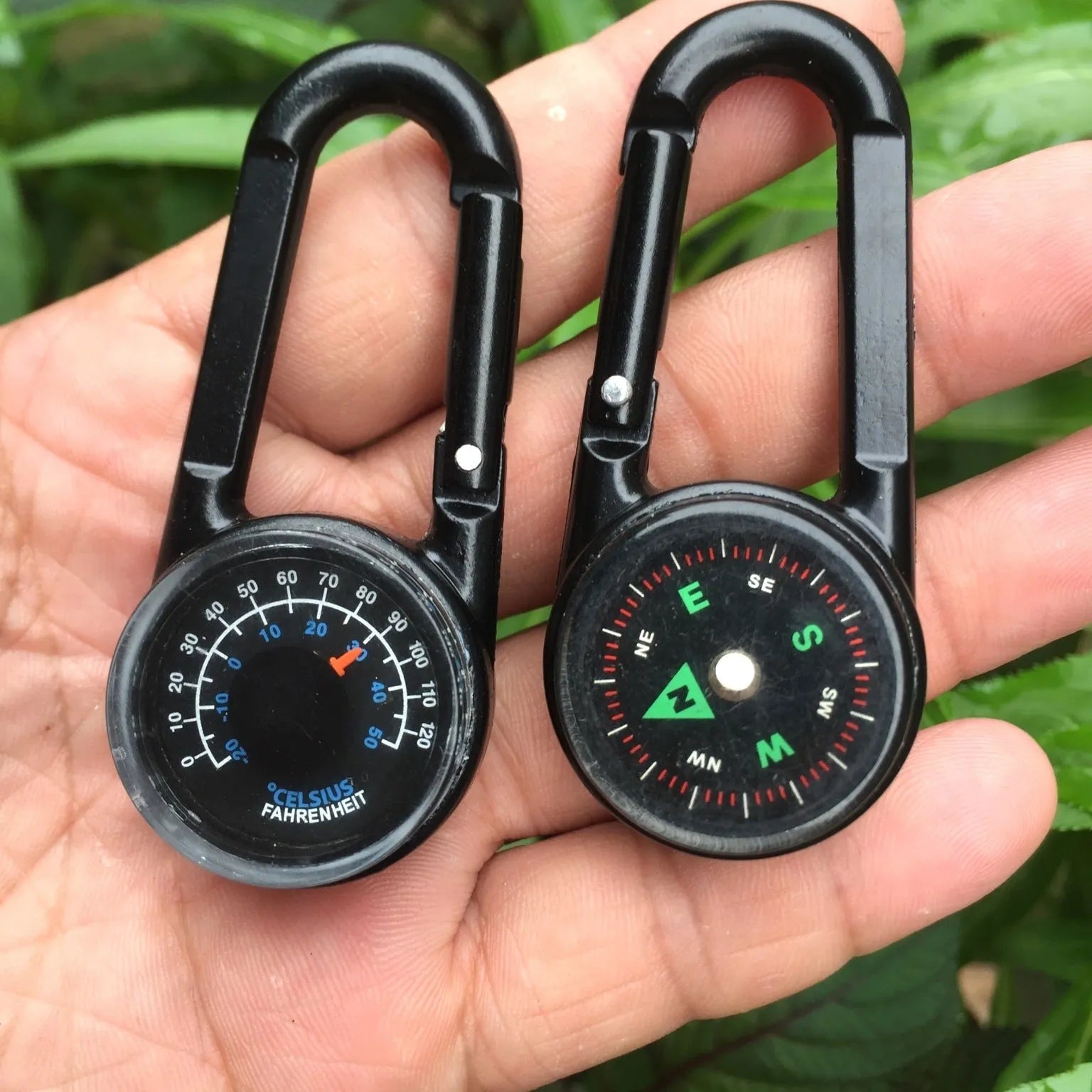 Black zinc alloy carabiner with built-in circular compass and rectangular thermometer display.