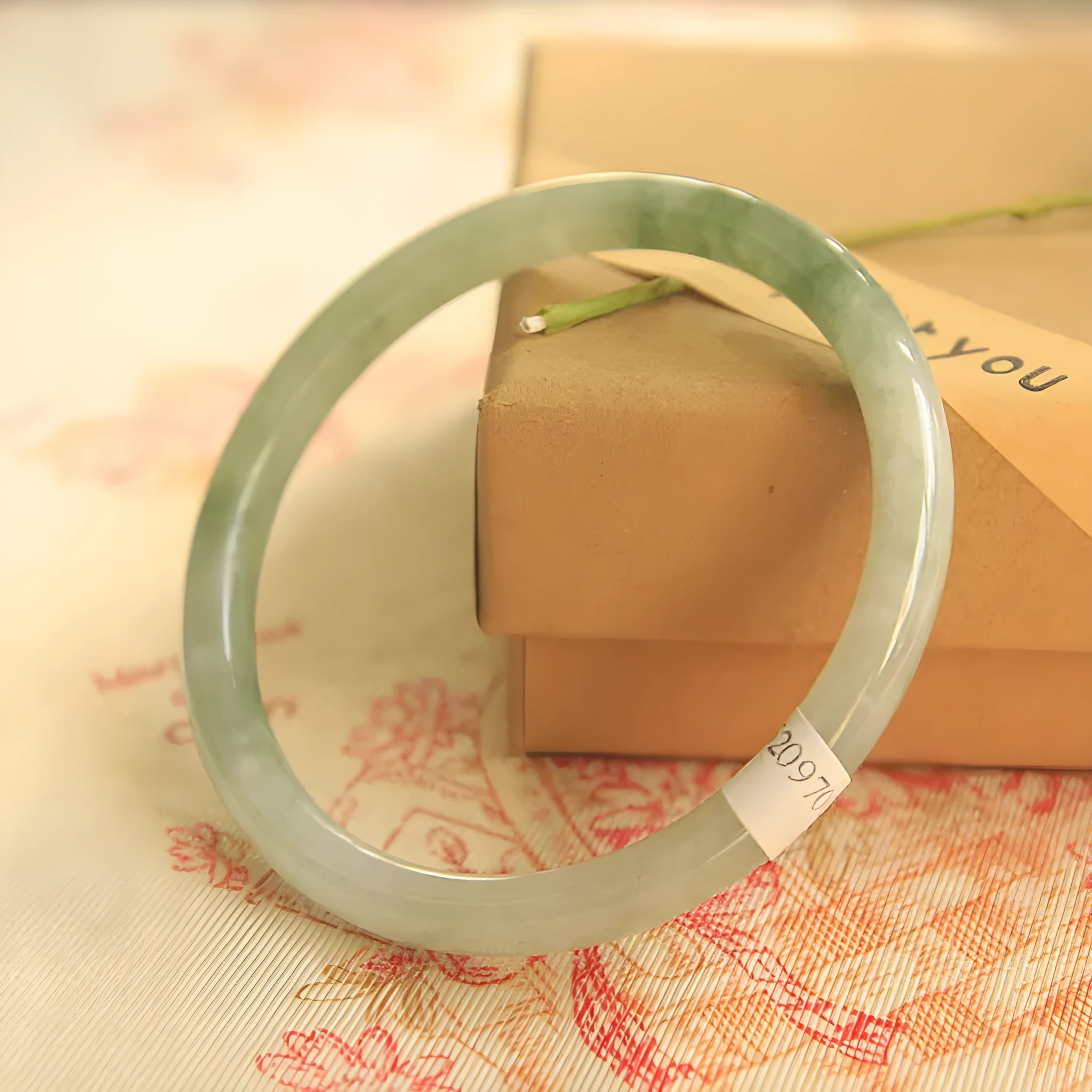 Green jade waxy finish geometric Chinese style bracelet shown on wrist, 10mm width.