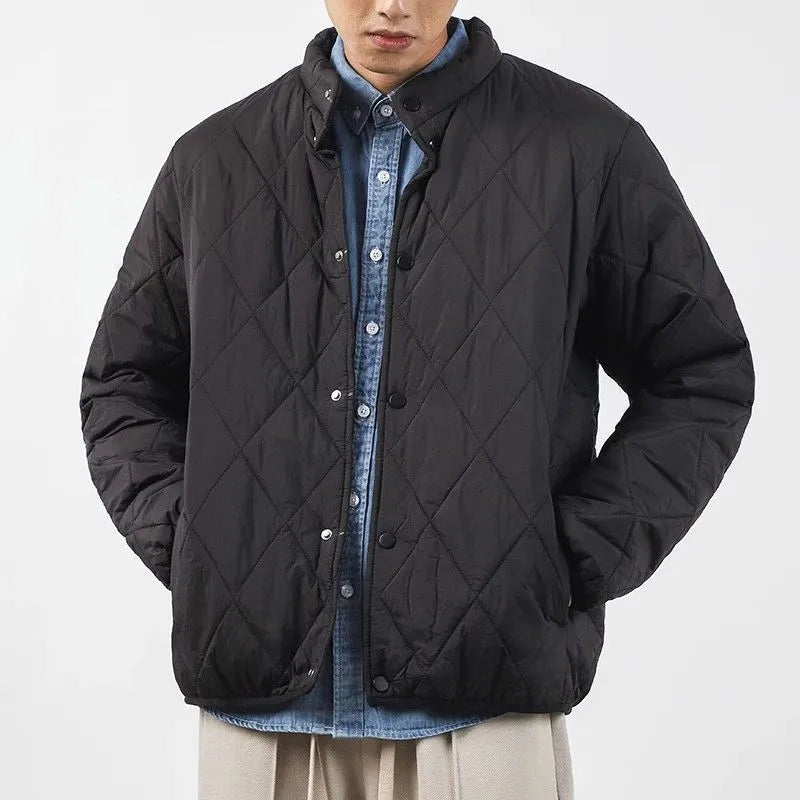 Men's black diamond lattice quilted winter jacket with extended length showing loose fit design
