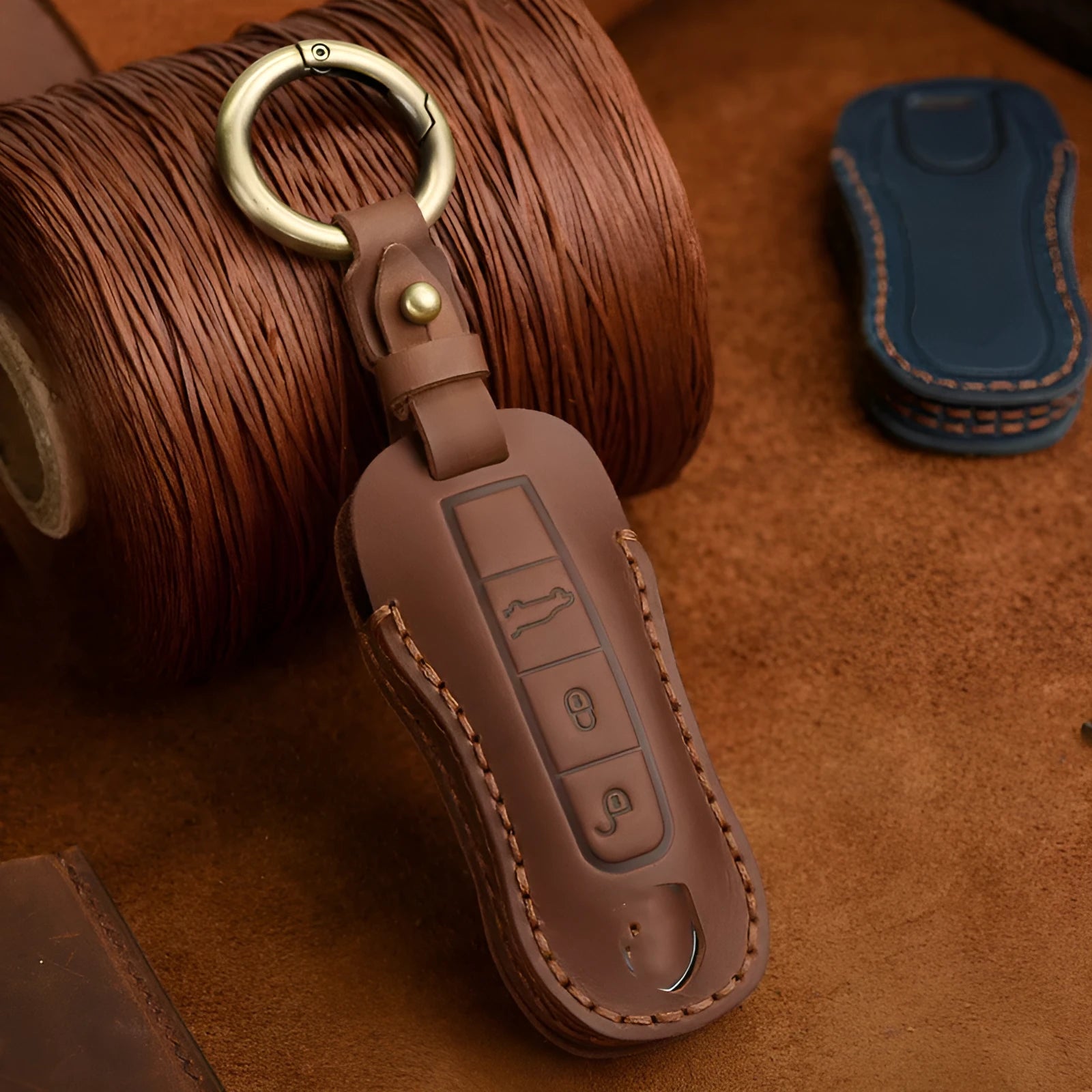 Genuine cowhide leather Porsche key cover with a retro bag buckle in blue and brown colour options.