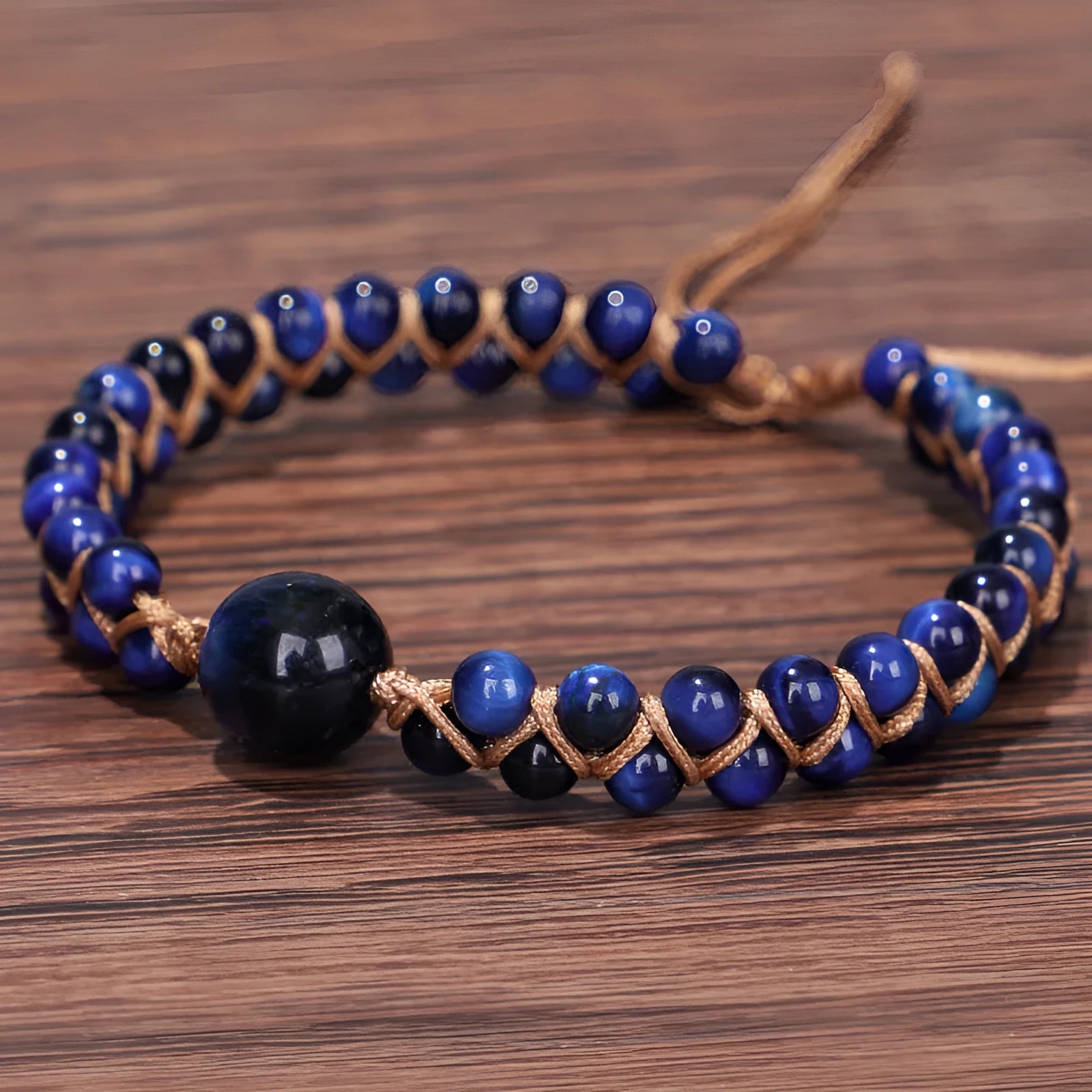 Handwoven geometric pull bracelet with blue tigereye stone beads on elastic band