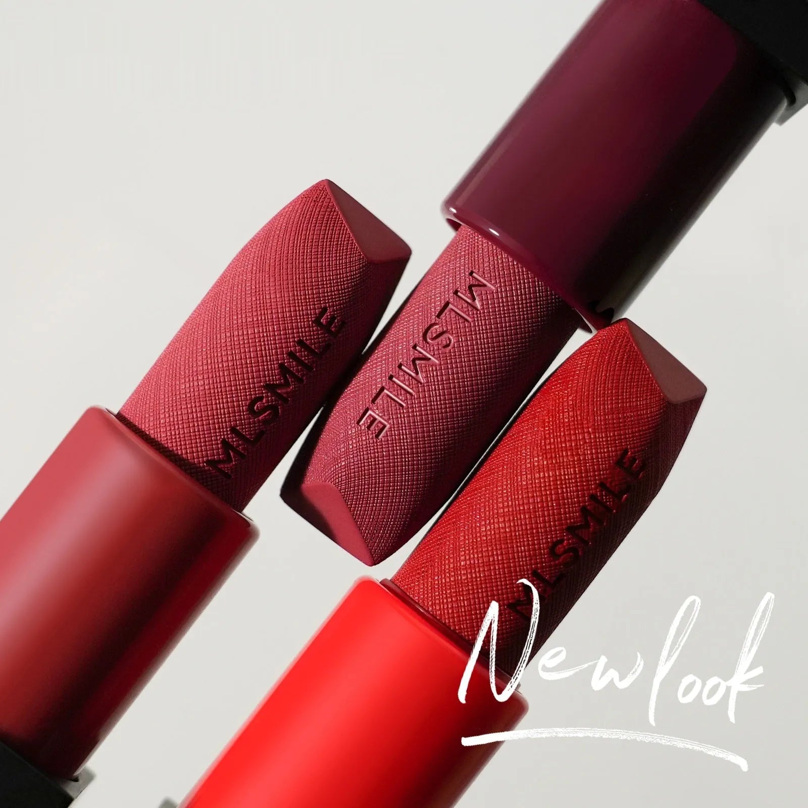 MLSMILE three embossed lipsticks in rose gold cases with decorative design