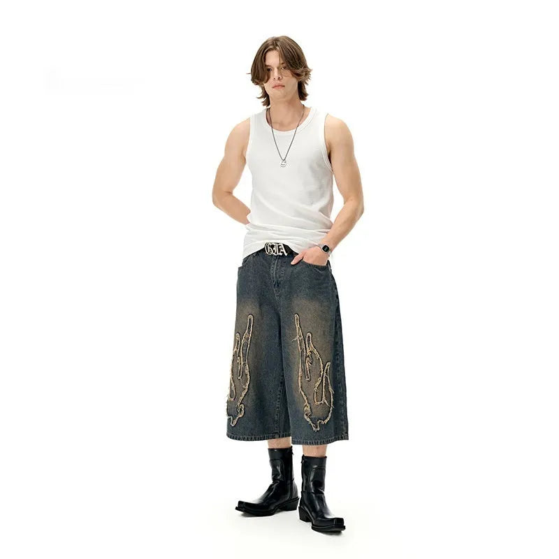 Men's cropped denim shorts with flame embroidery patches in straight cut design for summer street style
