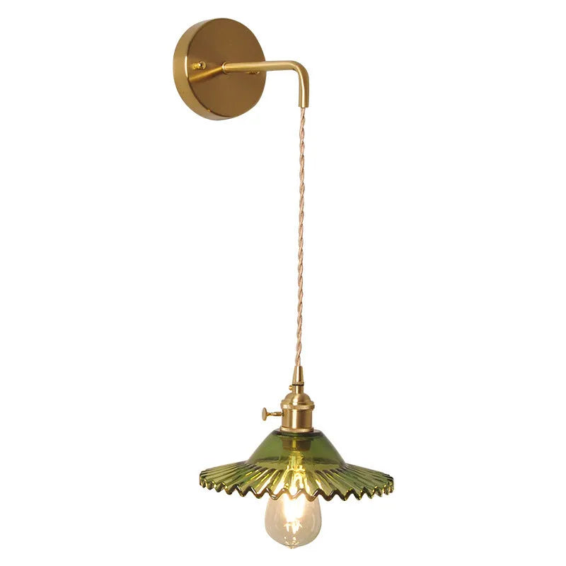 Retro brass lotus wall lamp with copper frame and glass shade on a wall