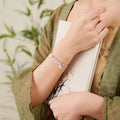Women's Hetian Jade diamond-shaped bracelet with lotus seedpod design on a woven strap.