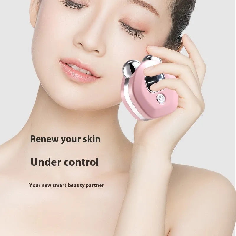Portable white, light blue, or pink hot compress and micro current facial massage instrument with double rollers.