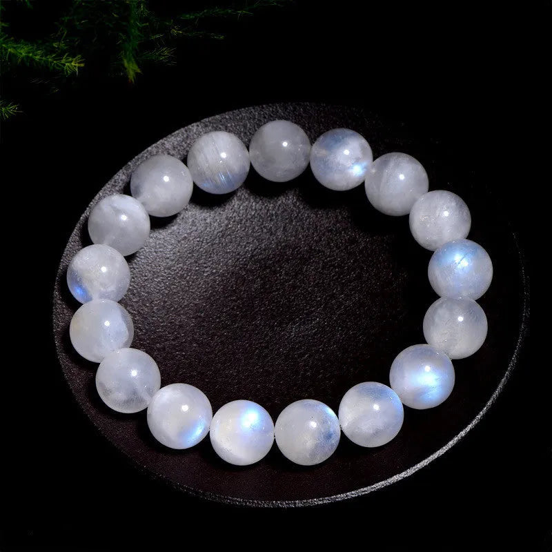 Natural blue moonlight polished moonstone round bead bracelet on wrist.