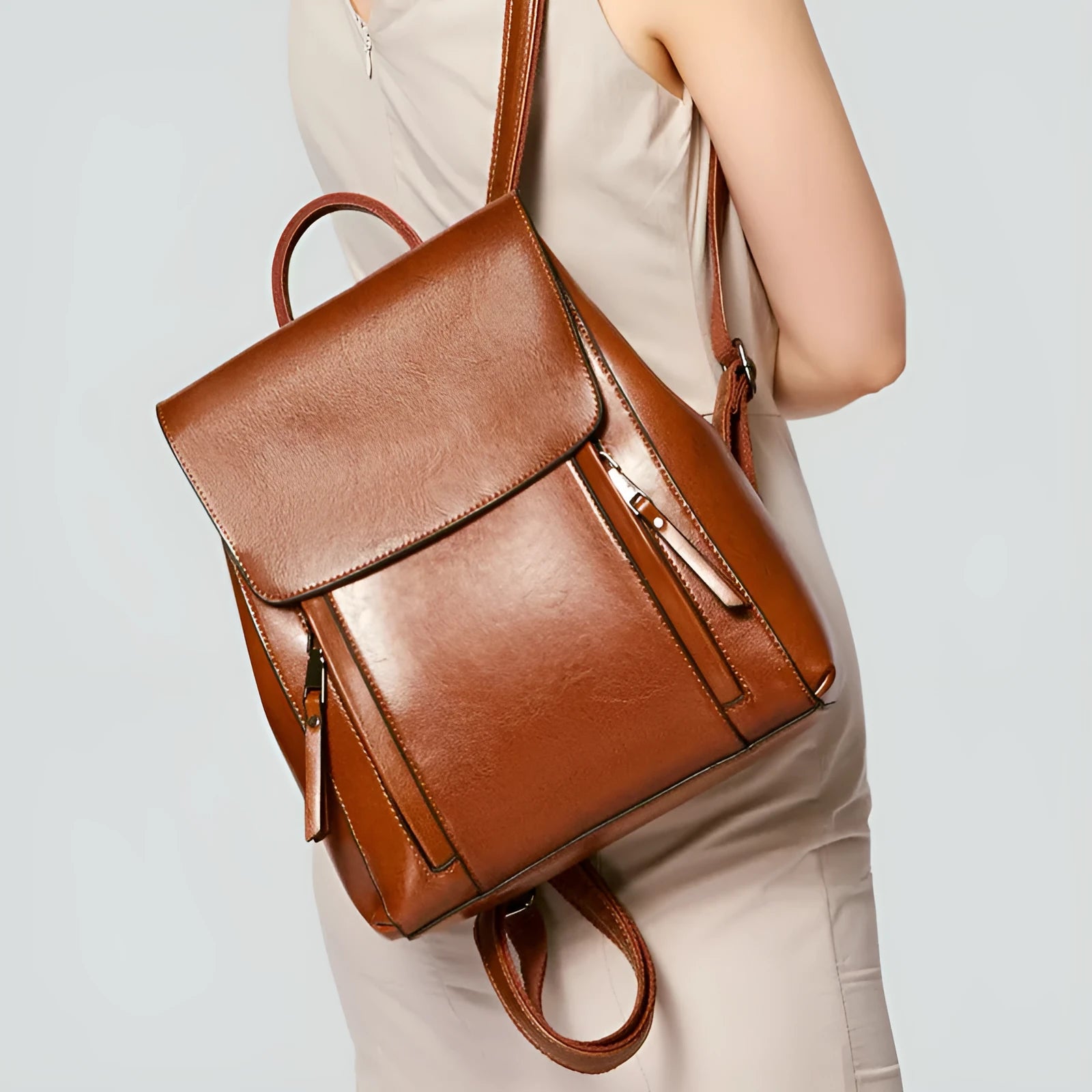 Large black genuine leather women's backpack with multiple pockets and double shoulder straps.