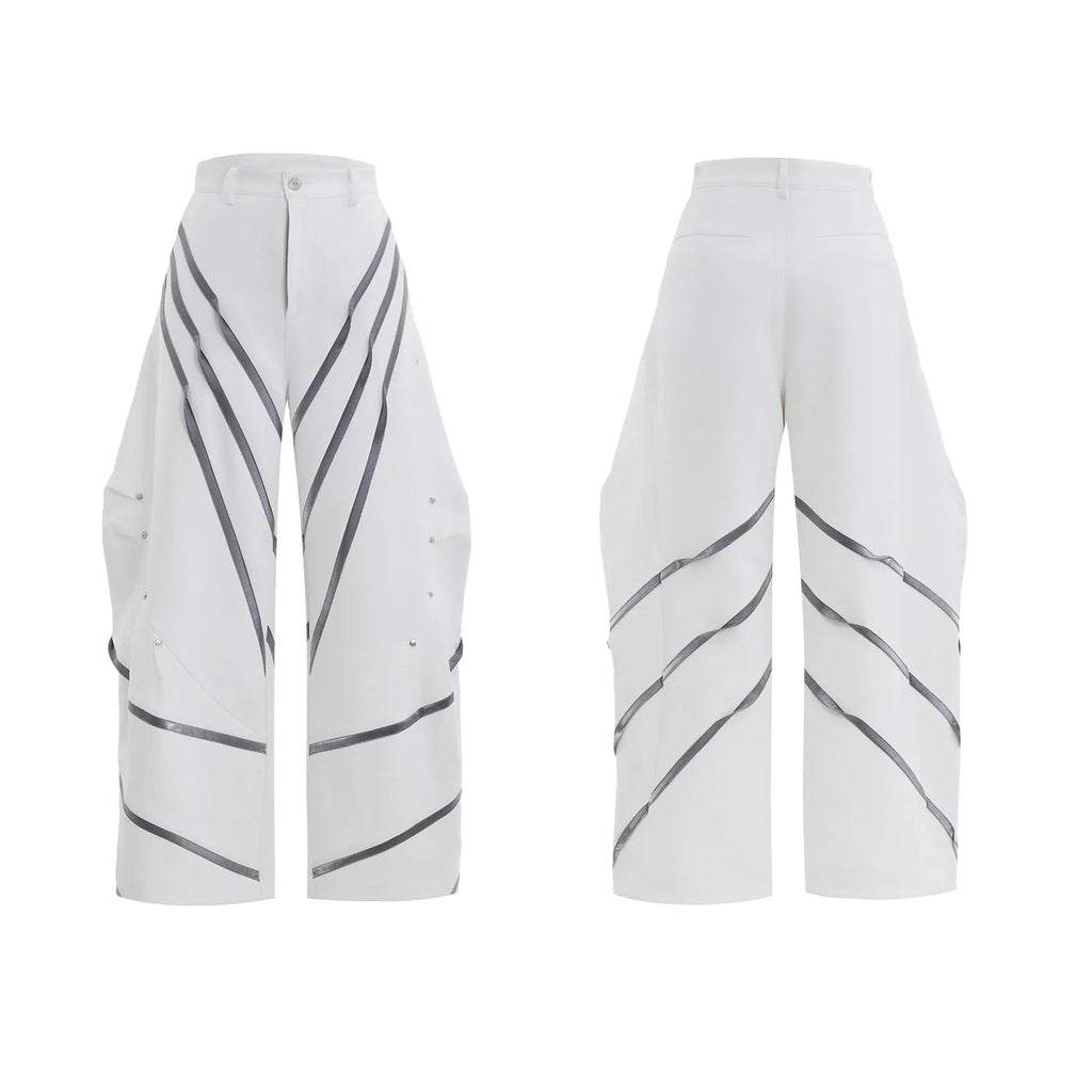 Men's black trousers with three-dimensional cut, metal striped rivets, and pleated detailing