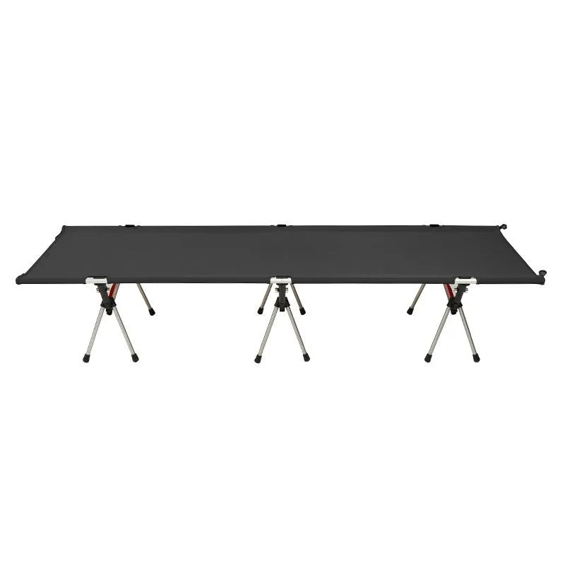 Lightweight portable folding bed set up outdoors in khaki colour with metal frame.