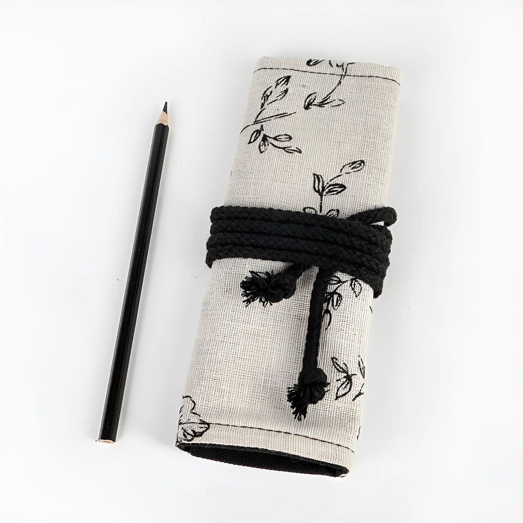 Square canvas pencil roll bag with black peony print design showing pencil pockets
