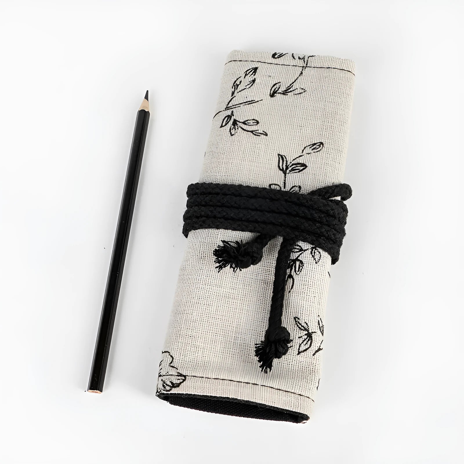 Square canvas pencil roll bag with black peony print design showing pencil pockets