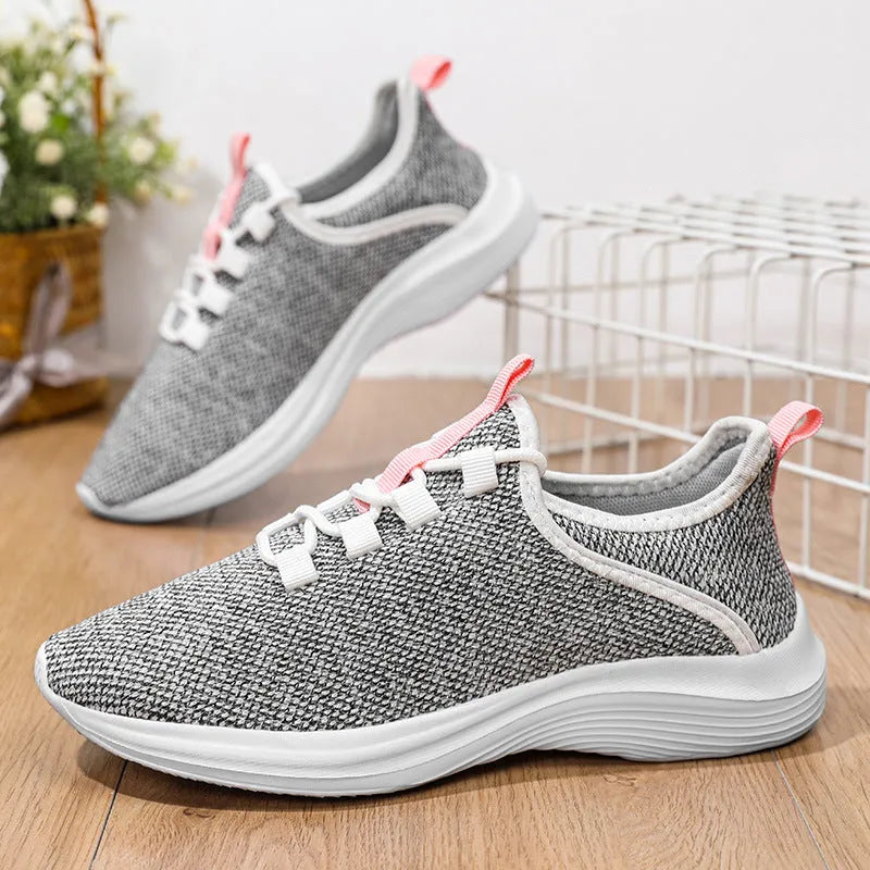 Women's low-top casual sneaker in grey with breathable mesh upper and lace-up front.