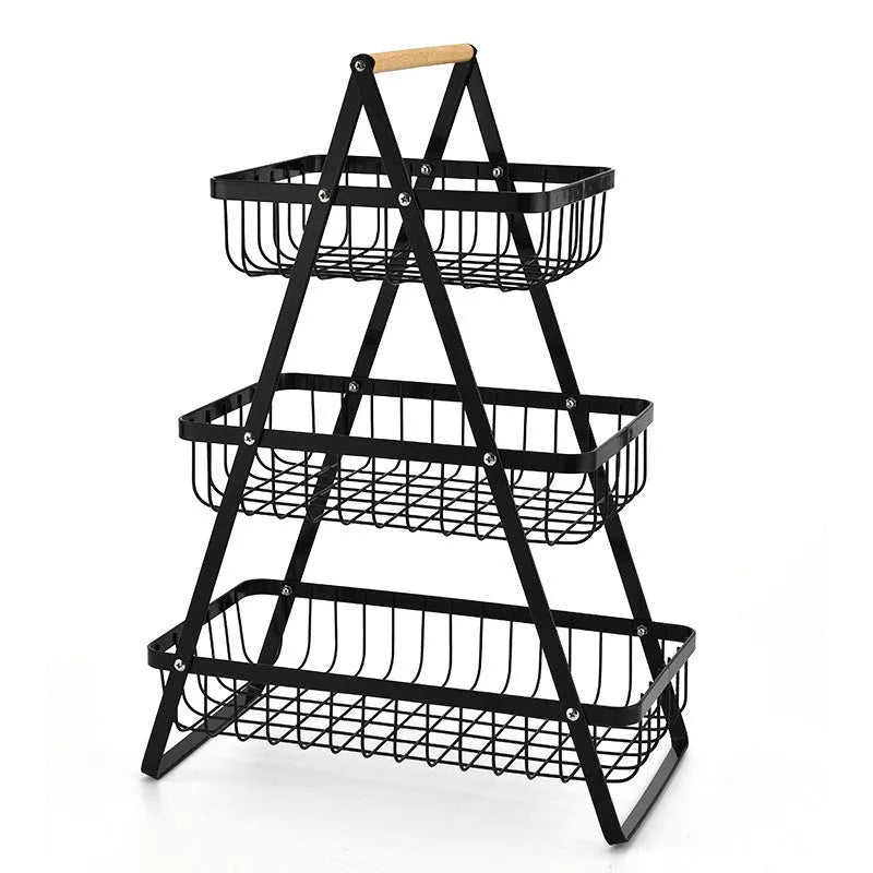 Black detachable double-layer iron fruit basket with a wooden carry handle on a tabletop.
