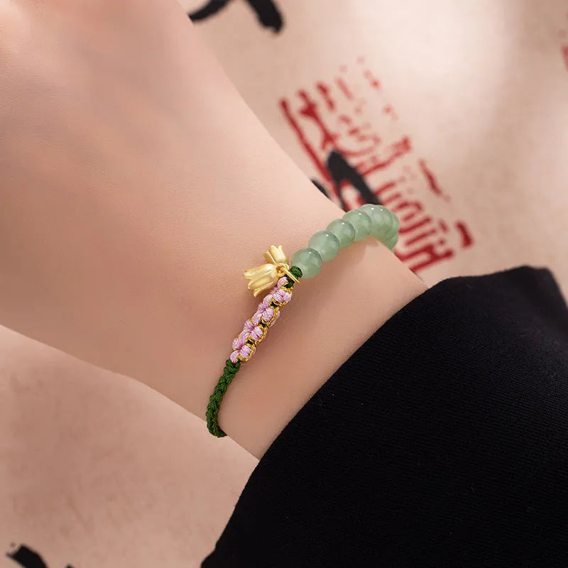Red rope hand woven women's bracelet with floral design in Lily carrying strap colour
