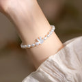 White rabbit bracelet with small pearl beads on an elastic string, silver rabbit charm.