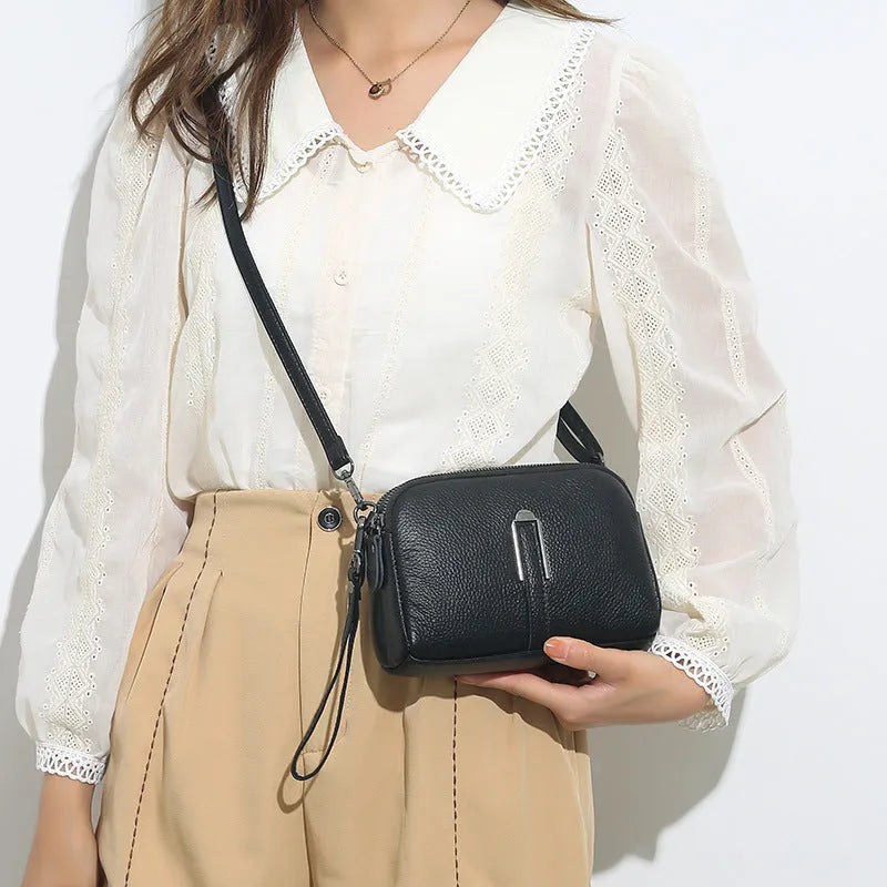 Women's black genuine leather shoulder bag showing square shape and compact 19x13x6cm size