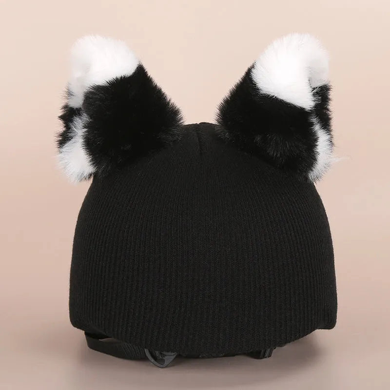 Plush fabric cute cartoon decoration hat placed on a ski helmet.