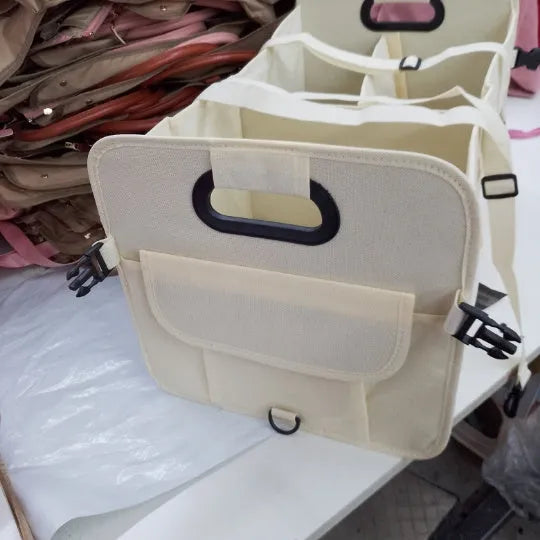 Black foldable fabric car trunk storage box with handles, shown with multiple compartments.