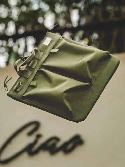 Marden canvas crossbody messenger bag in military green showing laptop compartment and shoulder strap