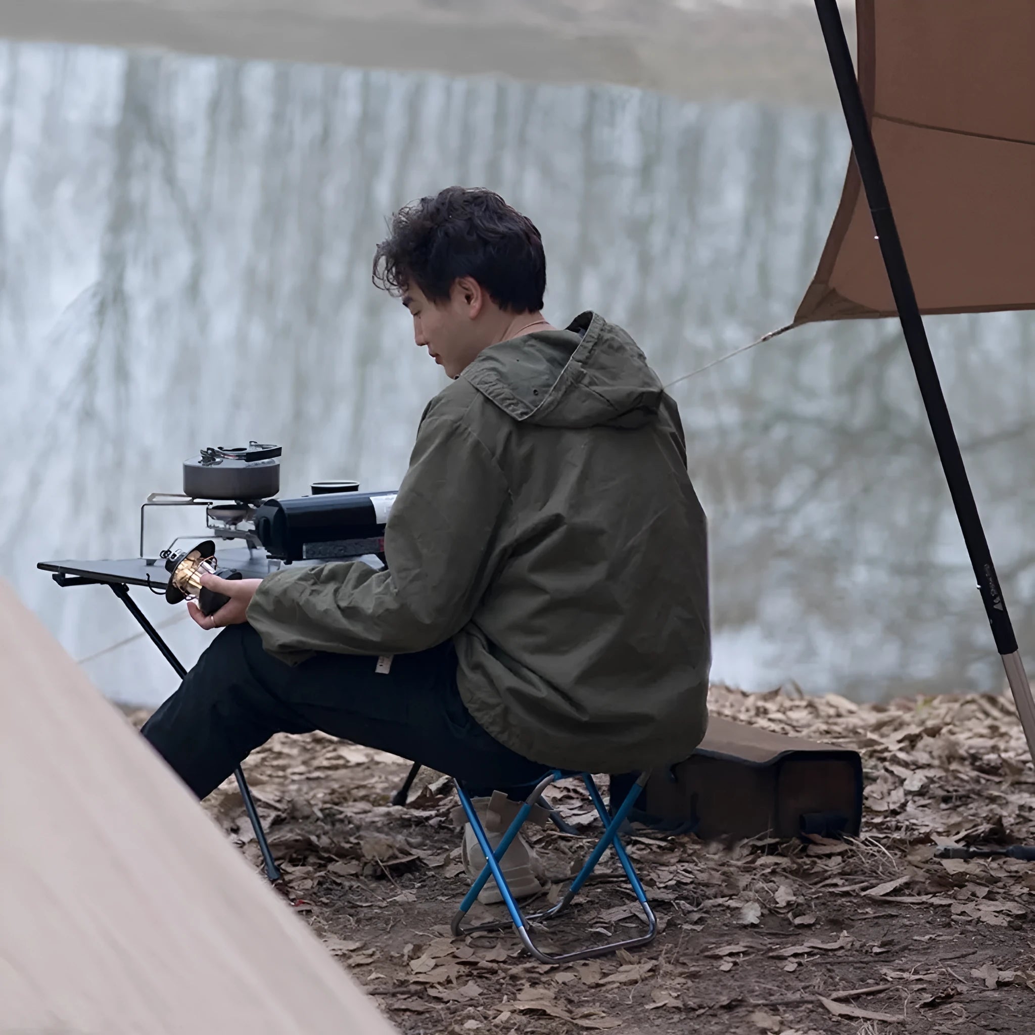 Black aluminium alloy portable folding camping stool shown in folded and unfolded positions.