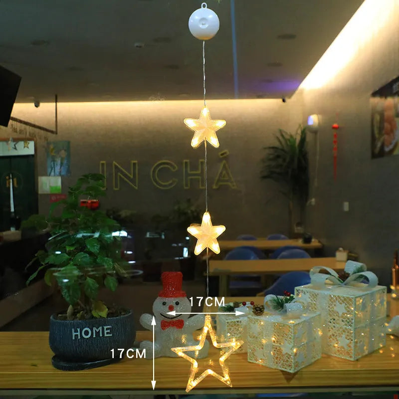 Set of three battery-powered LED Christmas pendant lights with suction cups, showing star, tree, and deer designs.