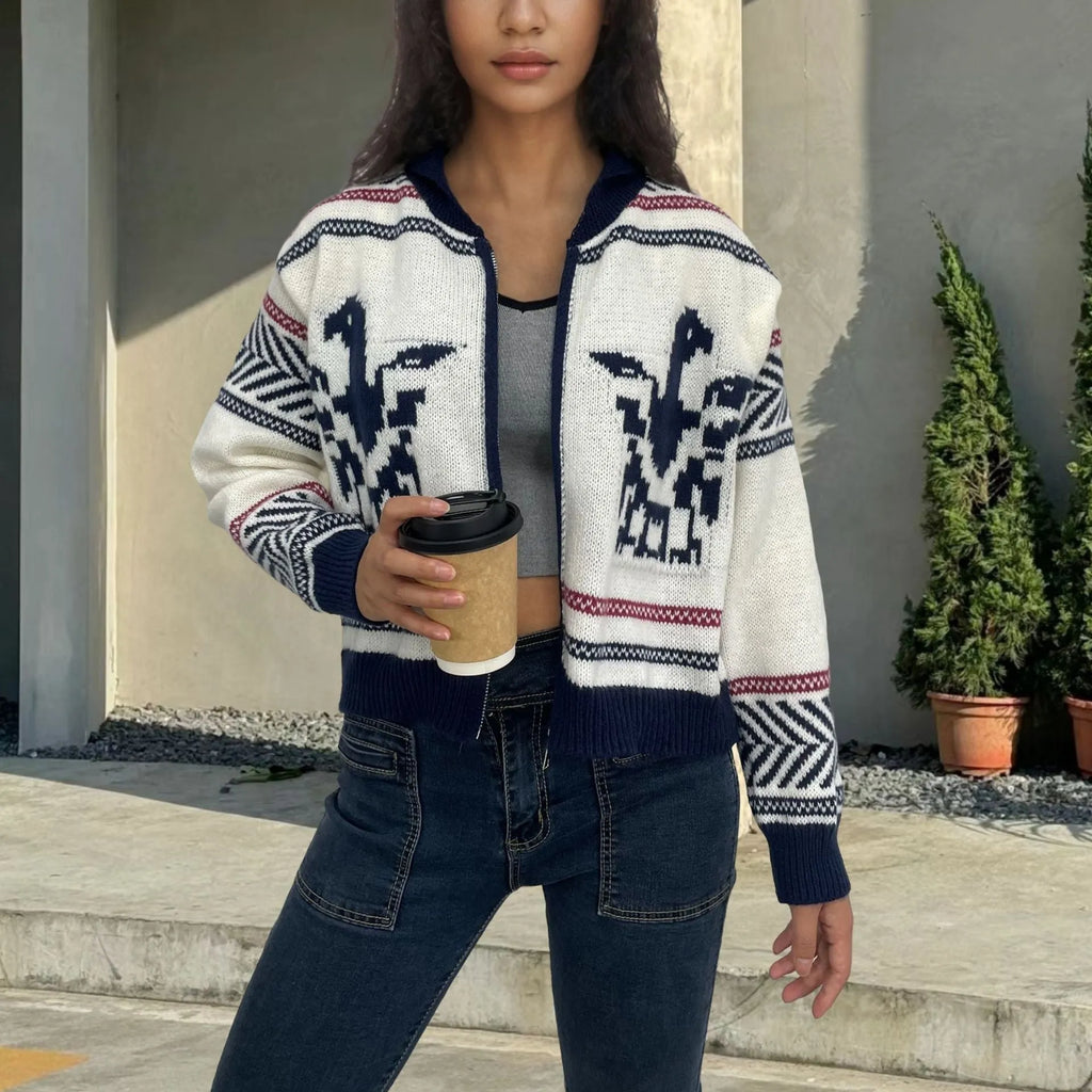 White women's cardigan with front zipper, lapel collar, and contrasting stripe jacquard pattern.
