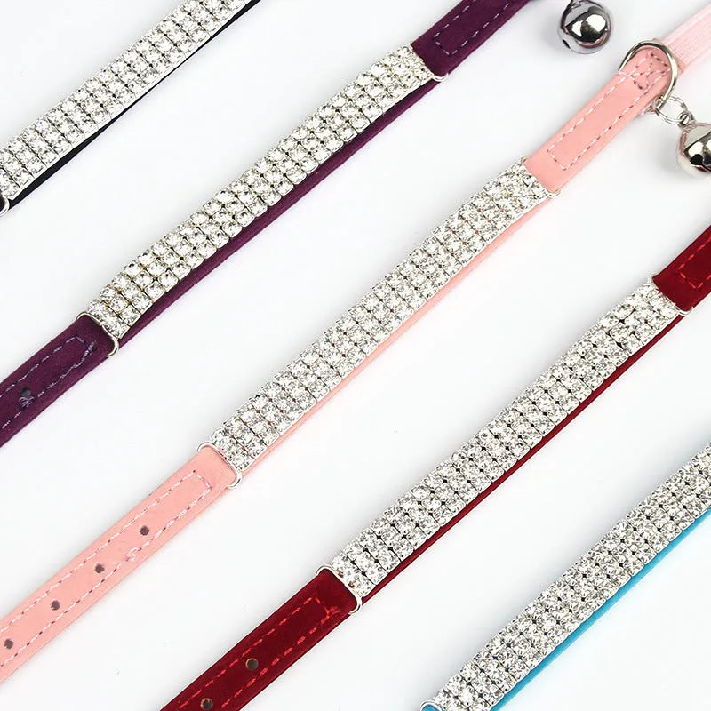 A black velvet cat collar with a rhinestone decoration, showing the adjustable buckle.