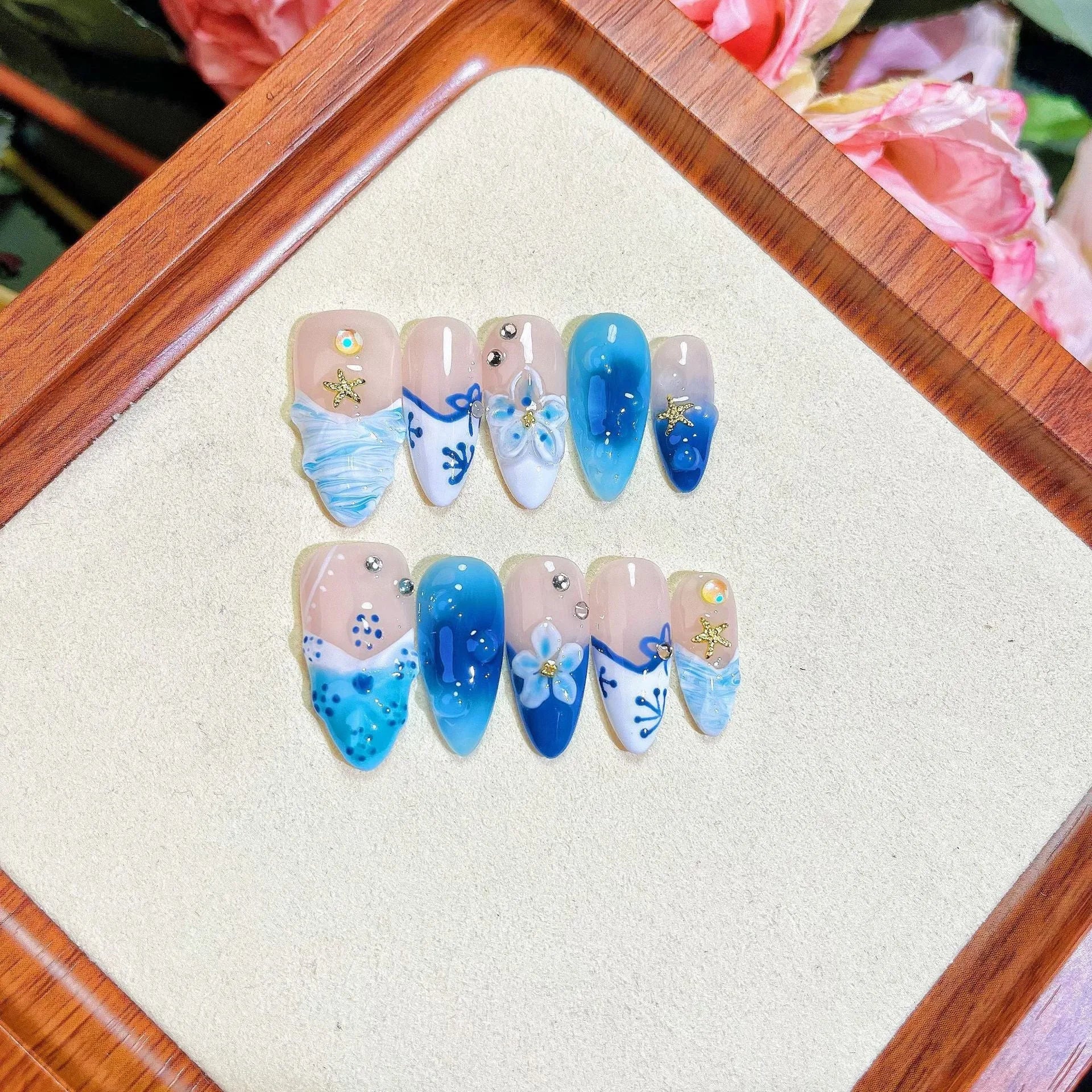 Blue plastic false nails with hand-painted carved summer ice transparent design in four sizes