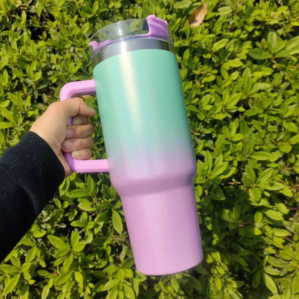 Large stainless steel vacuum insulation cup in a gradient colour, showing its tall 27.5 cm cylindrical shape.