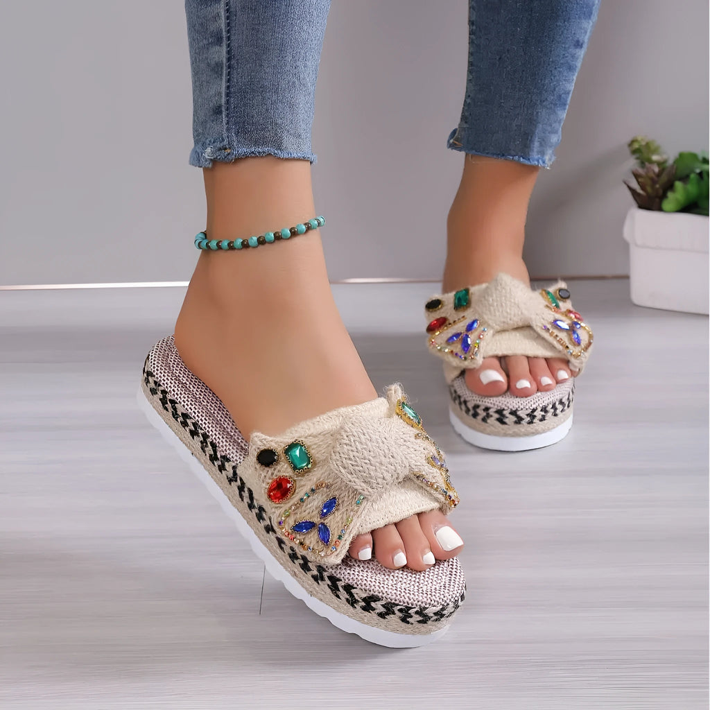 Creamy-white women's platform sandals with beach bow style and cloth construction on model foot