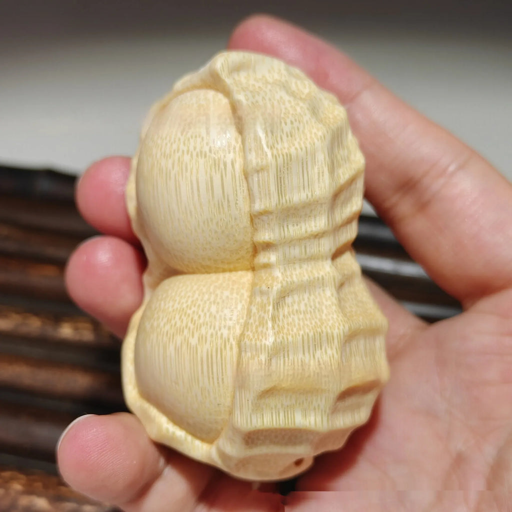 Modern simplicity style solid bamboo carving peanut ornament on a neutral background.
