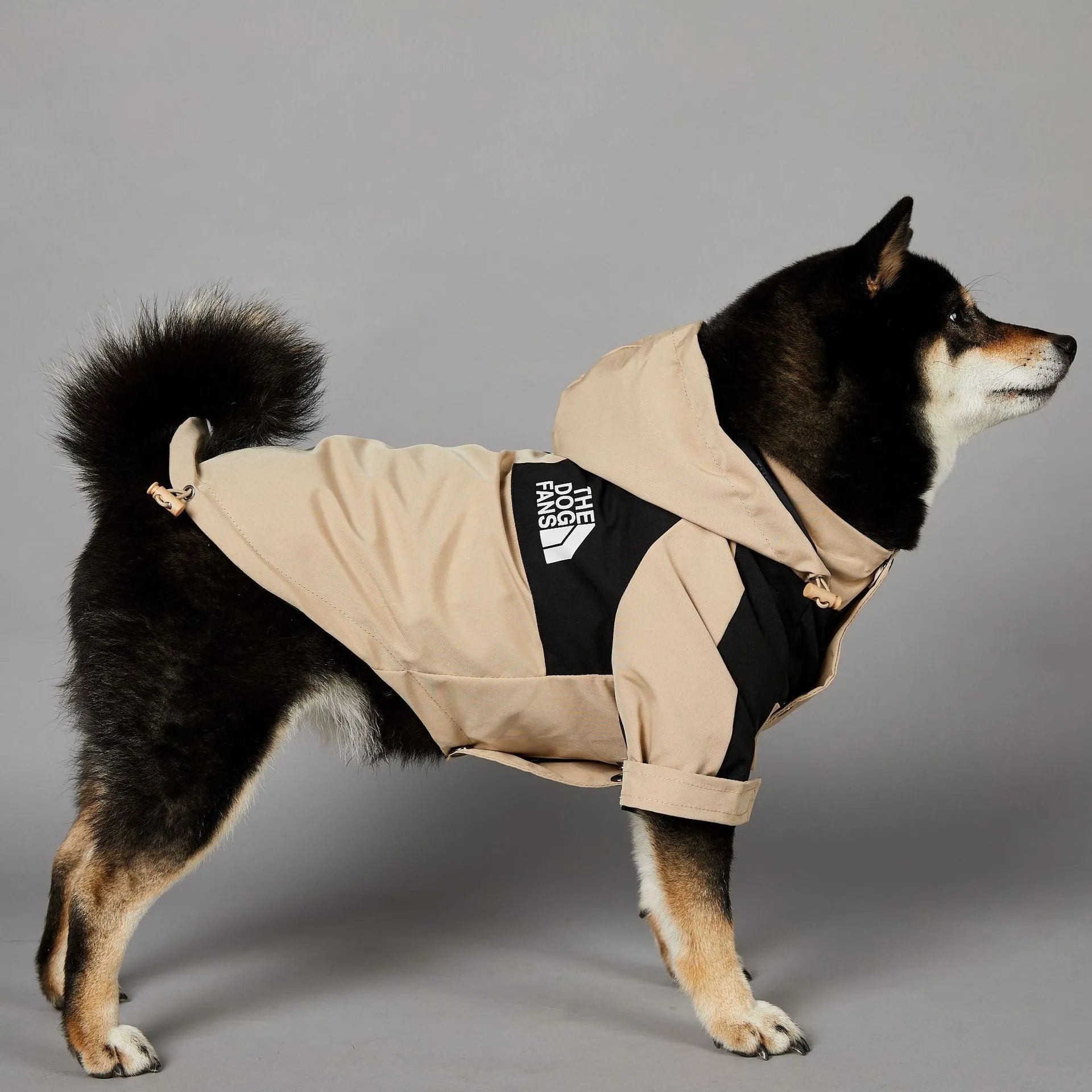 Khaki coloured polyester shell jacket for a dog on a size chart showing S, M, L, XL, 2XL, 3XL, 4XL, and 5XL.