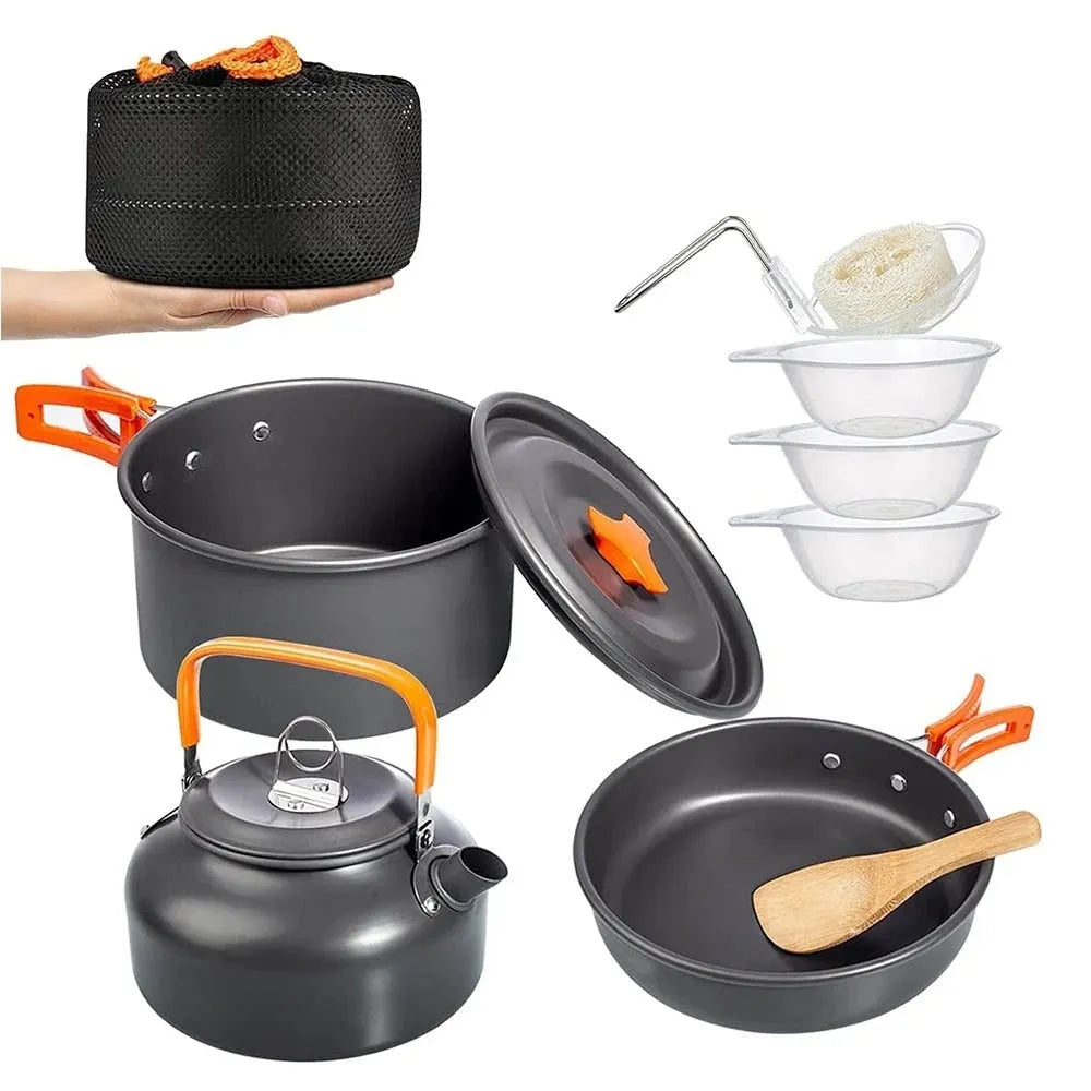 Orange camping cookware set with aluminium pots, pan, and utensils in a mesh bag