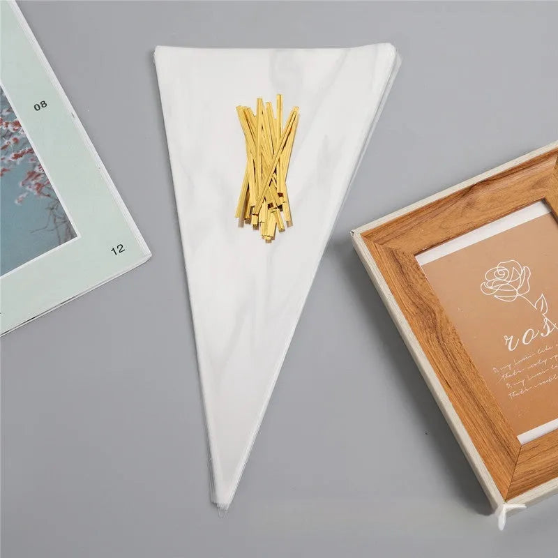 Clear triangle plastic packaging bag with a twisted wire tie closure on a white background.