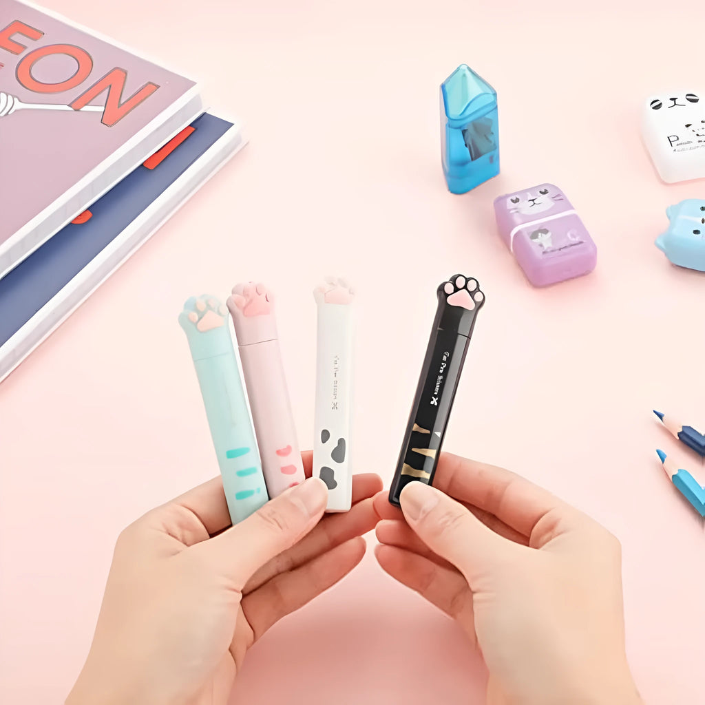 Closed and open views of cute cat paw design mini folding safety scissors on a craft background.
