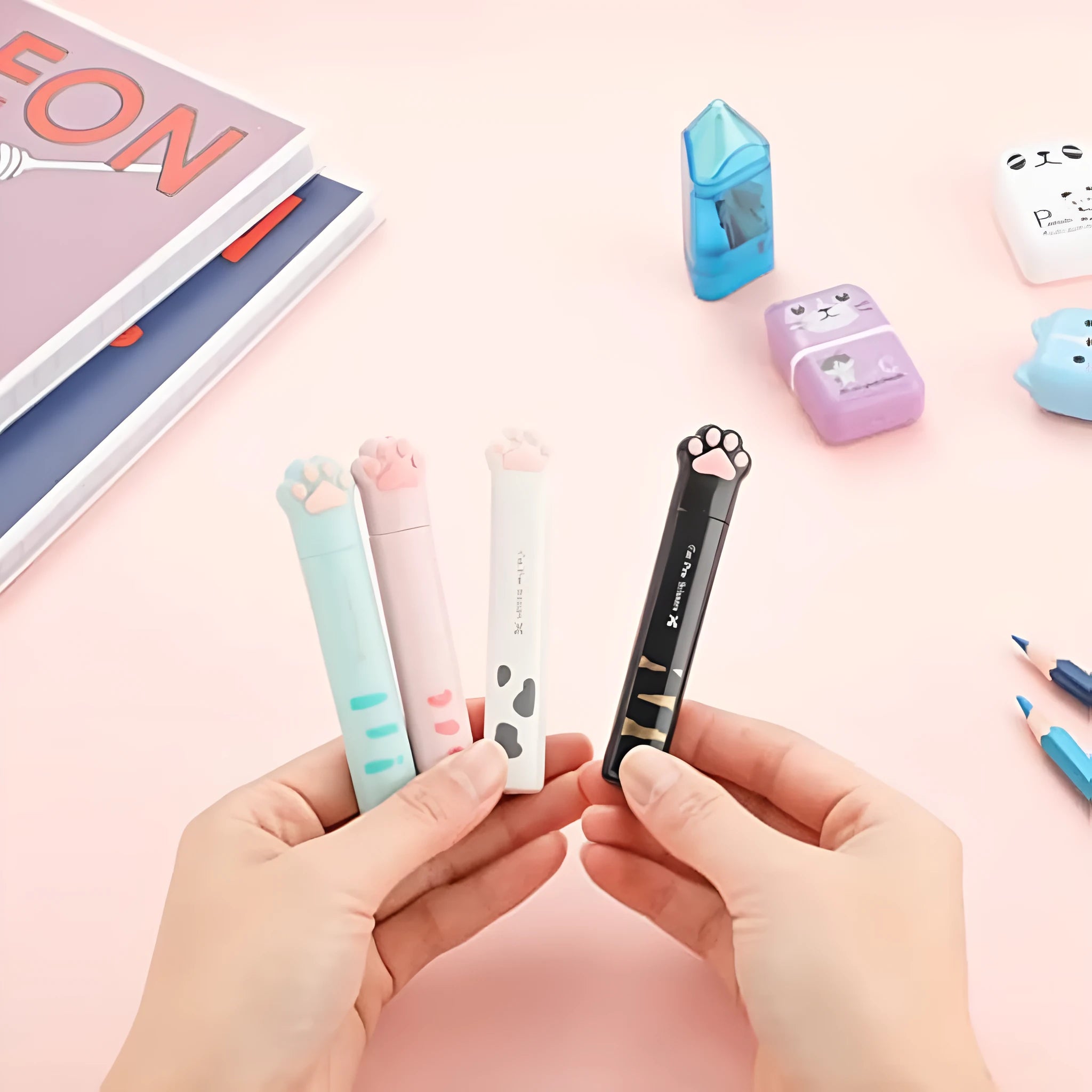 Closed and open views of cute cat paw design mini folding safety scissors on a craft background.
