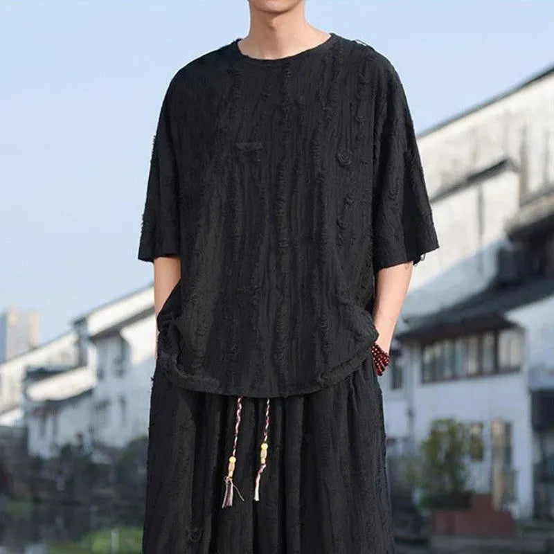 Men's thin knit two-piece set showing short sleeve top and loose cropped trousers in grey.