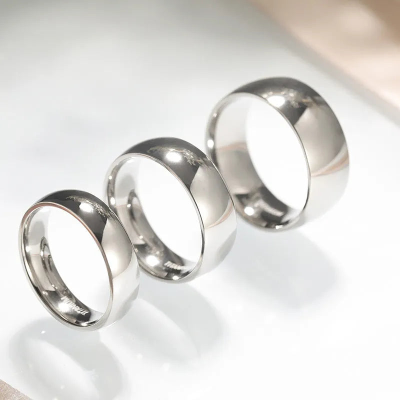 Silver titanium steel unisex ring shown in 2mm, 4mm, and 6mm width options.
