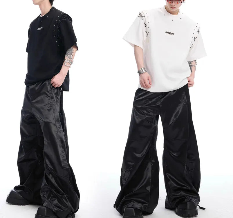 Deconstruction style short sleeve T-shirt with lace-up sides and cutout details in black or white.