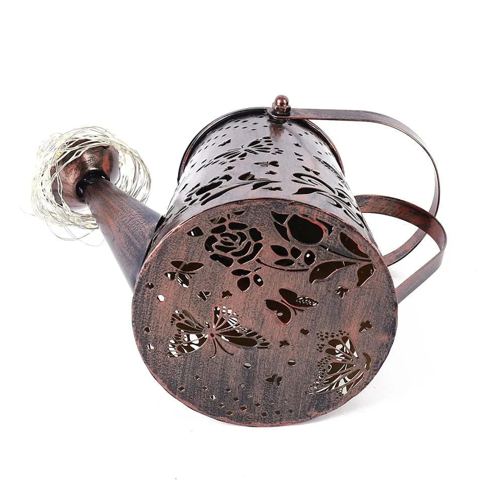 Solar garden lamp with iron tapered butterfly design emitting warm white LED light