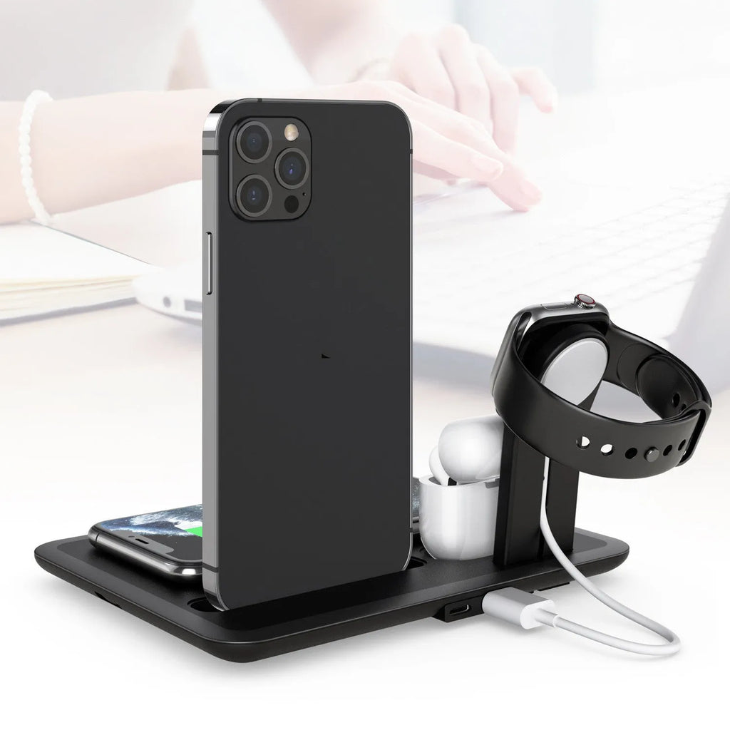 Black multifunction desktop wireless charger for phone, smartwatch and headphones on a wooden desk.