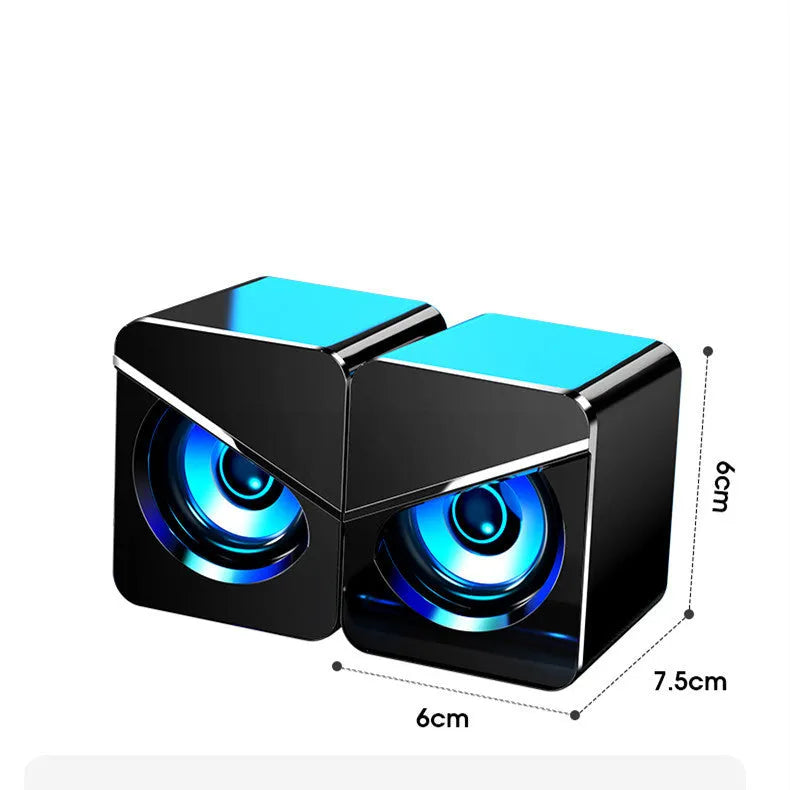 Compact black or white USB mini speaker for computer desktop use with wired connection.