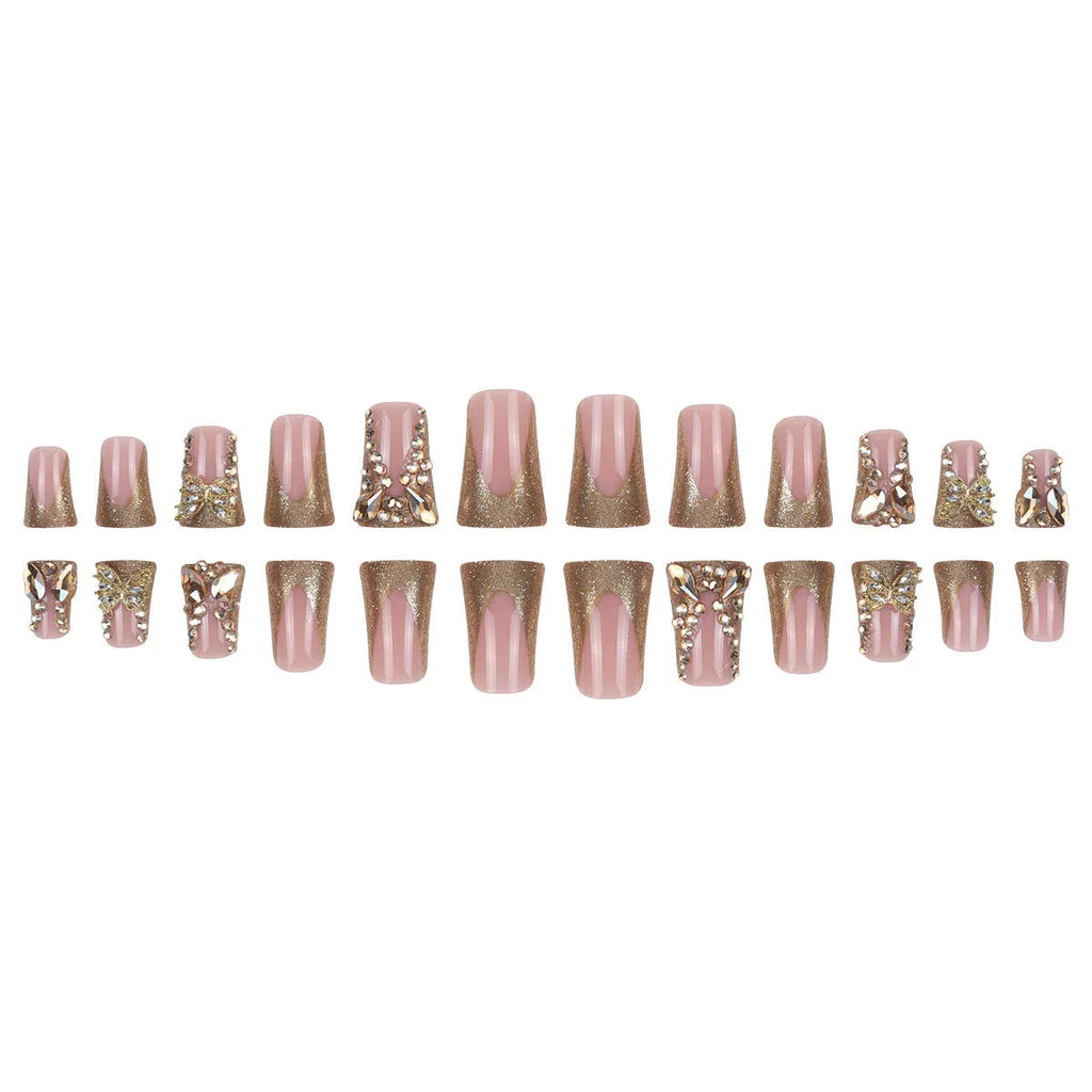 Pack of 24 golden diamond and debris-style butterfly nail stickers with a bottle of glue.