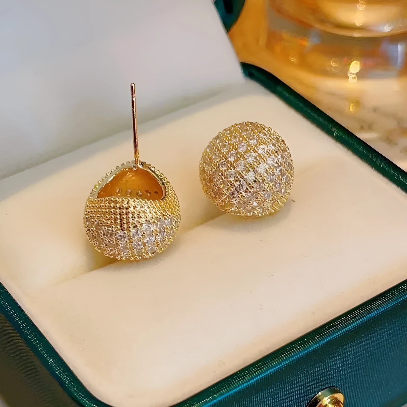 Golden beans shaped clip earrings with diamond crystals in drop geometric design