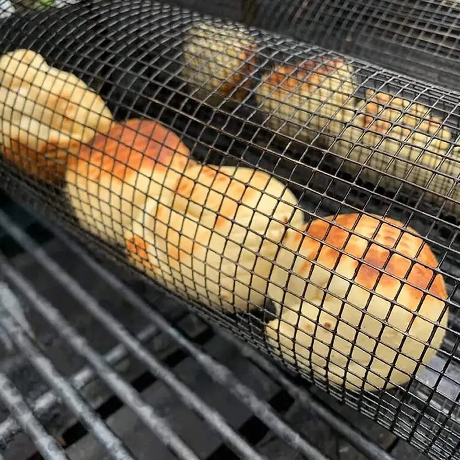 Stainless steel rolling barbecue grill basket with mesh cylinder for cooking vegetables and meatballs