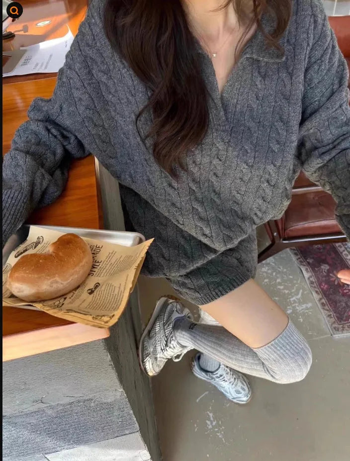 Women's creamy-white cable knit sweater and shorts knitted suit set on a hanger