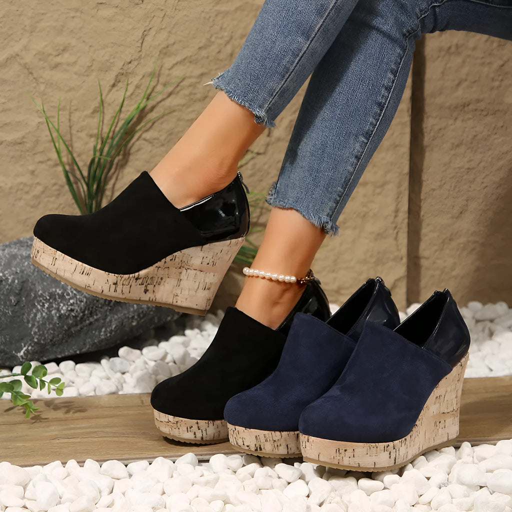 Women's wedge heels in black suede and leather patchwork with round toe and back zipper closure.