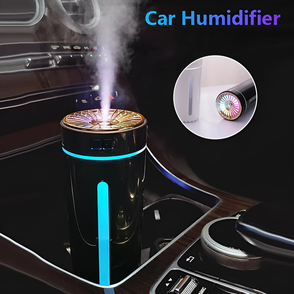 Black portable ultrasonic humidifier with colourful LED lights on a car cup holder.