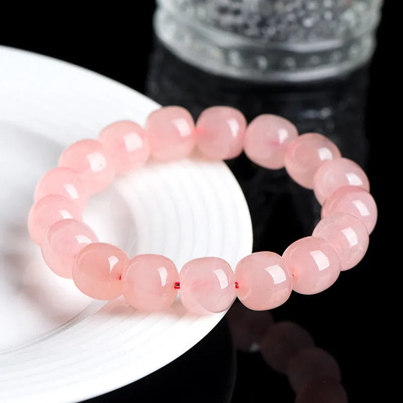 Natural pink crystal bracelet with geometric barrel-shaped beads measuring 8-10mm